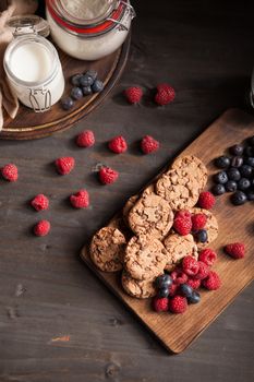 Top view of delicious and freshly baked chocolate chips with milk and blueberries. Tasty food.