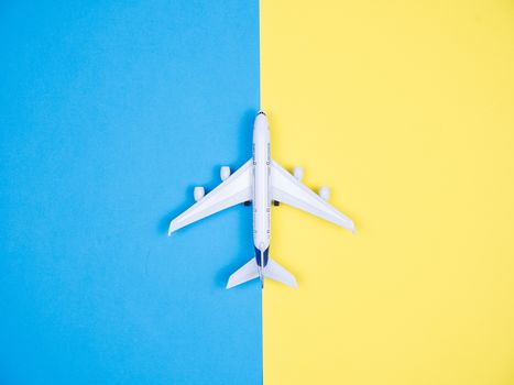 Flat faly top view of aeroplane toy over blue background. Model way of transportation.