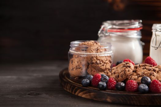 Fresh milk with delicious and freshly baked oatmel chocolate biscuits. Healthy snack.