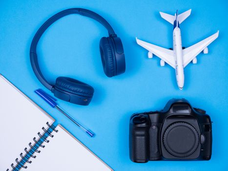 Top view of different film maker accessories over blue background. Modern accoessories for photographers.