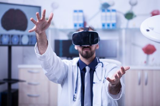 Portrait of young doctor using virtual reality technology for health problems. Doctor wearing virtual reality headset.