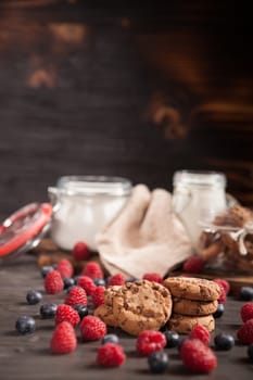 Fresh bluebarries and raspberries around delicious chocolate chips. Healthy snack.