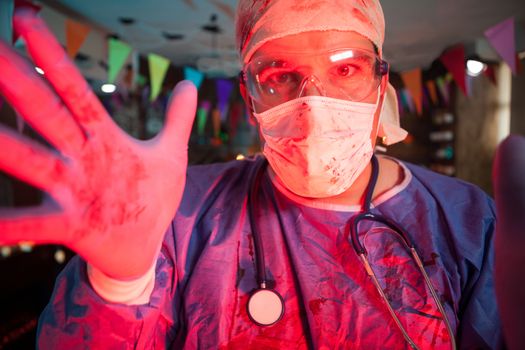 Close up of doctor with blood on his costume at halloween party. Celebrating halloween.