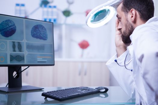 Doctor in a hospistal laboratory reading a braing x-ray. Modern medicine.