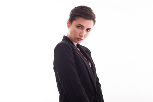Beautiful fashion model making serious face expression for the camera over white background. Suit jacket.