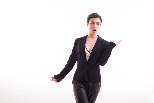 Fashion model looking amazed wearing black jacket in studio over white background. Gorgeous girl.