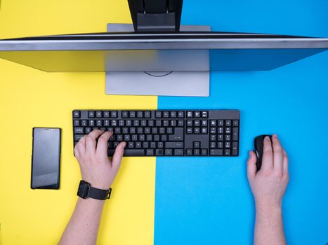 Flat lay top of man's hands on computer from his office. Freelancer working on his computer.