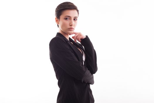 Attractive young woman in stylish black jacket posing over white background looking at the camera. Modern outfit.