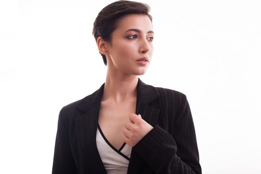 Beautiful young caucasian woman wearing a stylish black jacket over white background. Girl posing. Fashion studio.