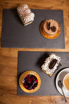 Top view of sweet decorated cake with fresh fruits in a coffee shop. Delicious cake with white cream on top. Cake with tasty biscuit.