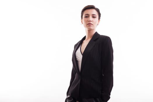 Beautiful young caucasian girl in a stylish black jacket looking into the camera over white background. copy space available.