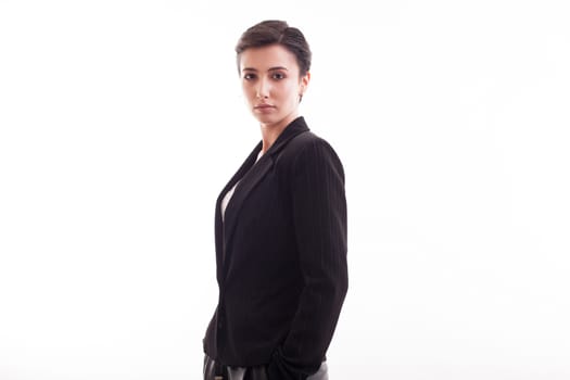 Gorgeous young fashion model looking at the camera wearing a black jacket in studio over white background. Pretty girl.