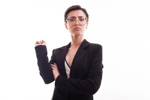 Cheerful fashion model looking angry into the camera over white background. Female in casual jacket.