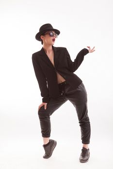 Stylish fashion model dressed in a fashionalble jacket and wearing a retro hat. Full body portrait.