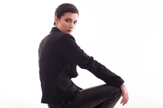 Caucasian beauty with short hairstyle wearing a black jacket over white background. Elegant look.