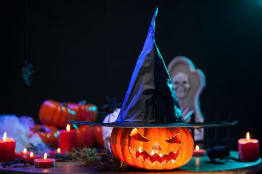 Haunted witch pumpking with a big black hat at halloween celebration. Halloween decoration.