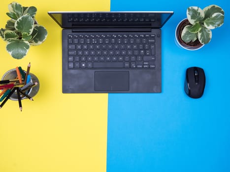 Flat lay top view of modern notebook over blue background. Copy space available.