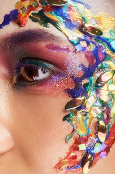 Beauty fashion art portrait of beautiful woman with flowing liquid paint. Fashion makeup. Beauty makeup. Caucasian woman.