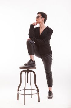 Portrait of thoughtful fashion model posing in studio over white background. Full body portrait. Casual jacket.