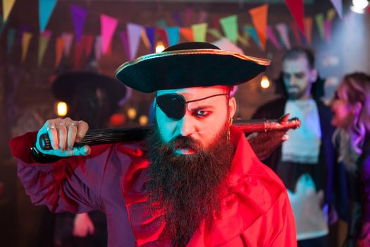 Portrait of angry pirate with one eye covered at halloween celebration. Man in a pirate costume.