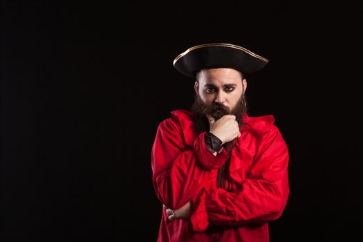 Man with a serious face dressed up like a caribbean sailor for halloween. Actor dressed up like a pirate.