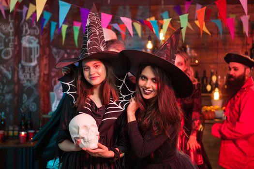 Portrait of excited young witches for halloween party. Beautiful witches.