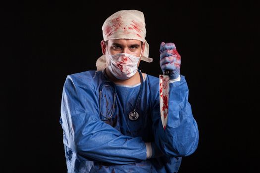 Crazy young doctor with pshycho eyes at halloween carnival. Doctor with mental disorder.