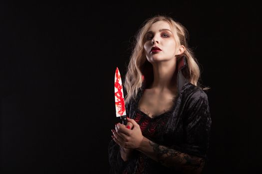 Portrait of sensual vampire woman dressed up for halloween carnival. Gorgeous vampire woman.