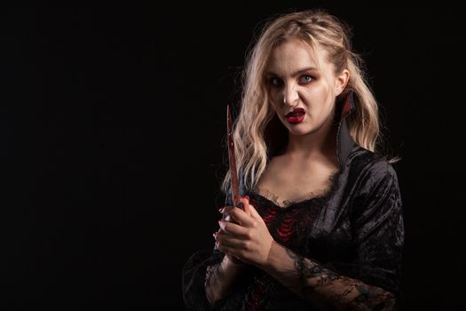 Portrait of beautiful young woman with vampire make up for halloween. Vampire goddess.