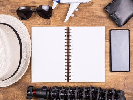 Top view of traveler blogger kit for summer vacation. Tripod. Glasses. Hat.