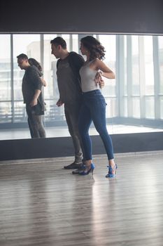 Beautiful girl in blue jeans dancing kizomba. Freedome expressed while dancing. Attractive young woman dancing.