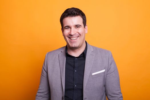 Portrait of young man smiling over yellow background. Attractive man. Happy man