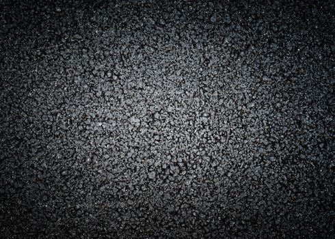 Black asphalt texture, dark background with strong vignette
