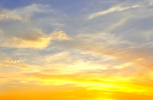 Beautiful high resolution panorama of orange and red sunset clouds in the evening sky.