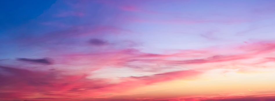 Beautiful high resolution panorama of orange and red sunset clouds in the evening sky.
