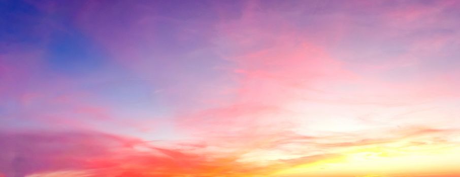 Beautiful high resolution panorama of orange and red sunset clouds in the evening sky.