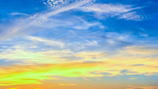 Beautiful high resolution panorama of orange and red sunset clouds in the evening sky.