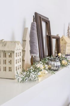 Neutral wooden Christmas holiday home decoration on a shelf, still life.