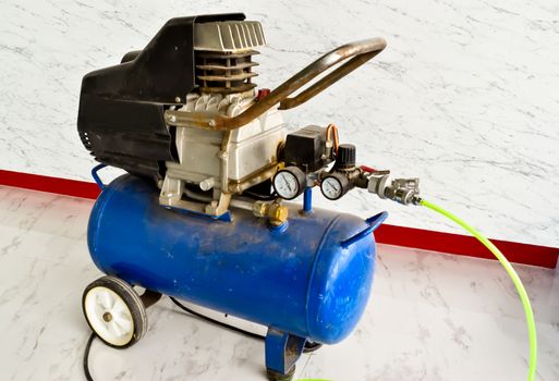 The old blue Air compressor in the construction area.