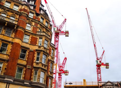 Several cranes on constructions sites at high buildings all over Europe.