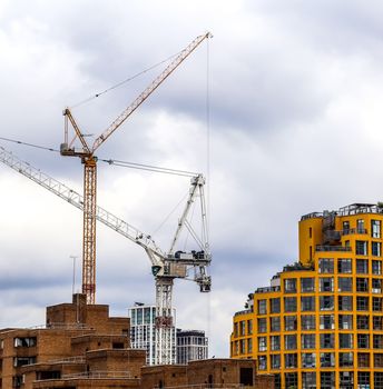 Several cranes on constructions sites at high buildings all over Europe.