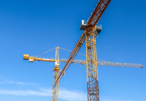 Several cranes on constructions sites at high buildings all over Europe.