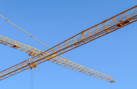 Several cranes on constructions sites at high buildings all over Europe.