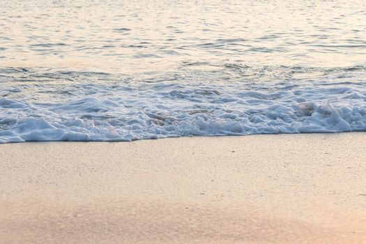 waves on the beach at sunset