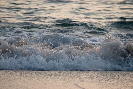 waves on the beach at sunset