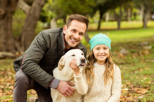 Young family with a dog on an autumns day