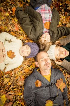 Young family doing a head circles on an autumns day