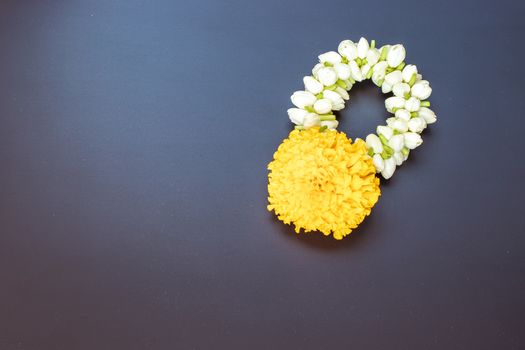 Thai traditional jasmine garland on black wooden table