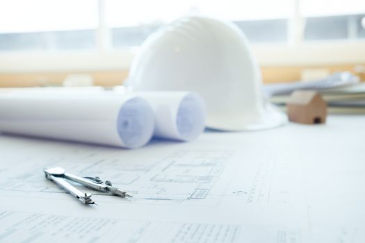 Construction equipment. Repair work. Drawings for building Architectural project, blueprint rolls and divider compass on table. Engineering tools concept. Copy space of Architecture and Engineer Desktop..