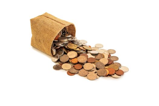 coins spilled from brown bag isolated on white background